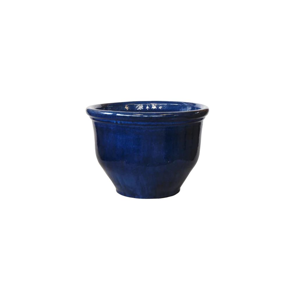 Round blue ceramic plant pot with glossy finish on white background